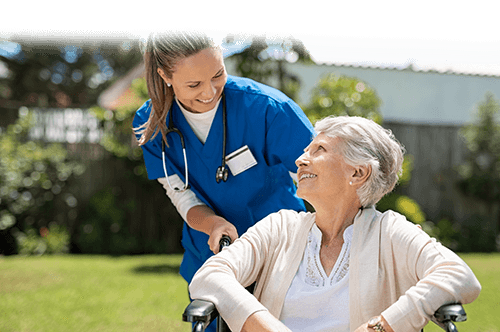 nurse helping woman in wheelchair at aston gardens pelican pointe